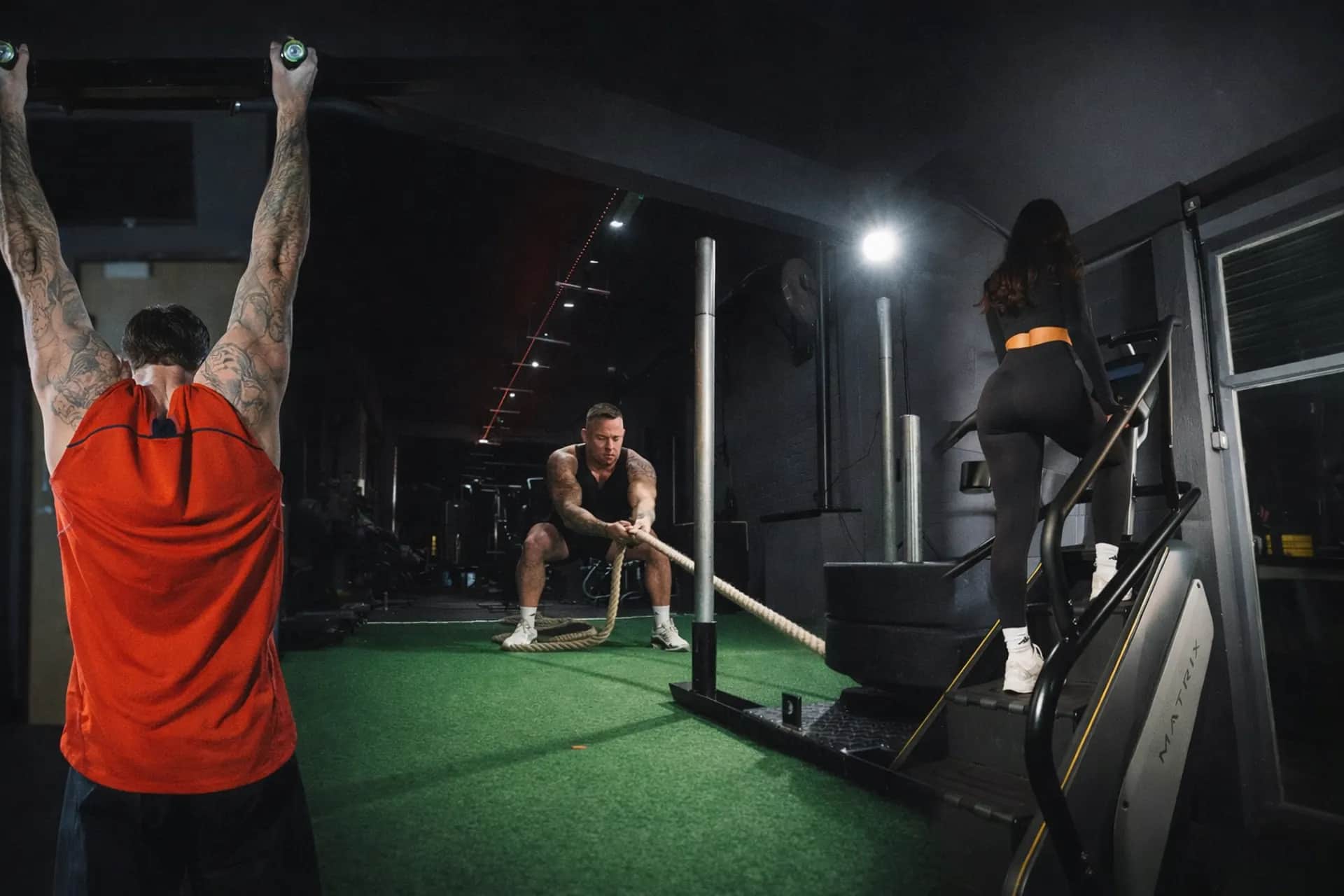 Members training at Performance Lab Grimsby — pull-ups, sled rope pulls, and stair climbing